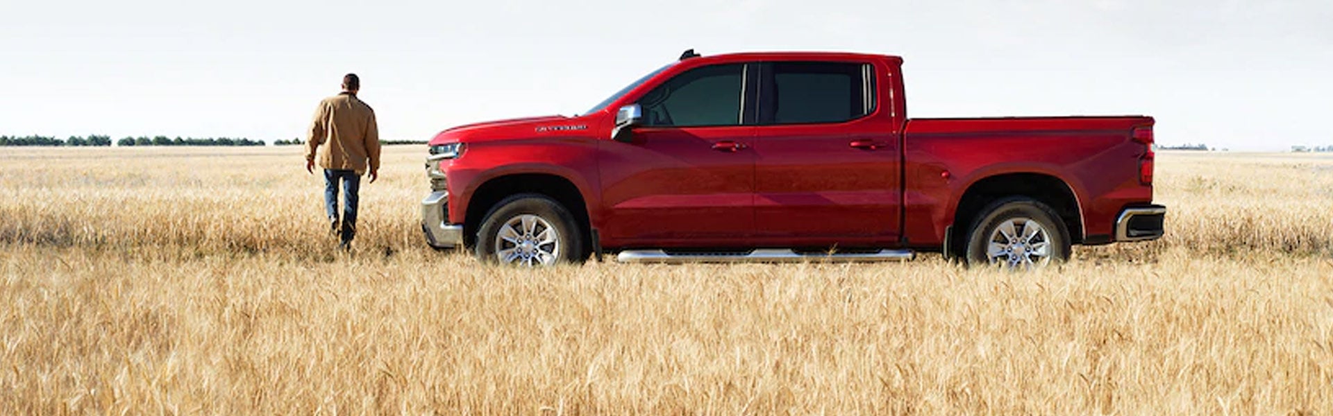 Chevrolet Silverado is parked in a wheat field