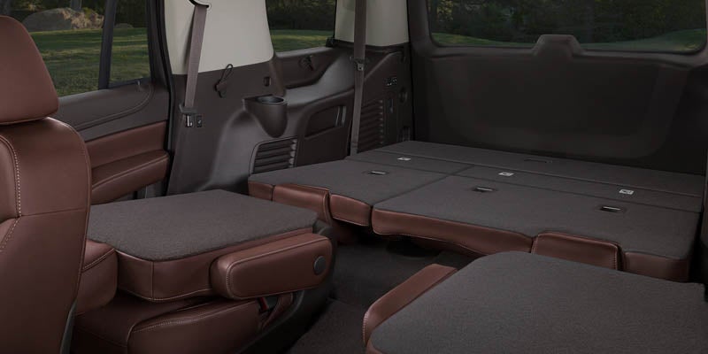 Folding the rear seats of a Chevrolet Tahoe showcasing the interior and additional spaces